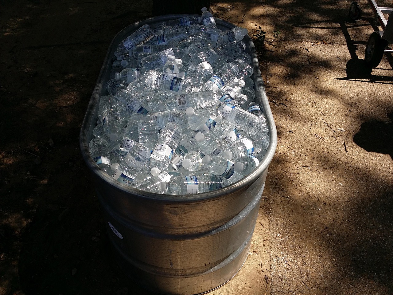 A large container of bottled water packed in ice
